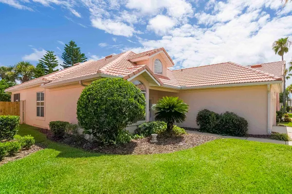 a front view of a house with garden