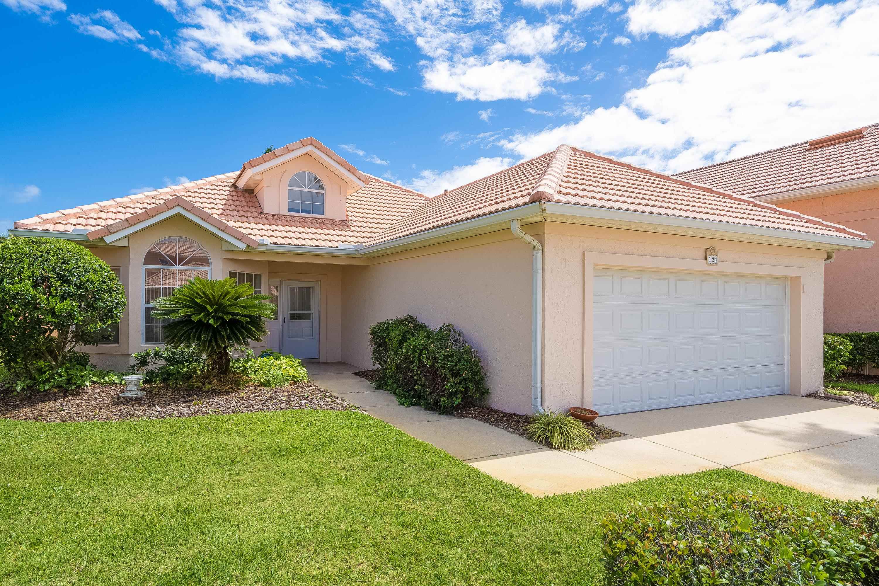 121 Tide Watch Drive St. Augustine, FL 32080 - Photo 9 of 49 a front view of a house with a yard and garage
