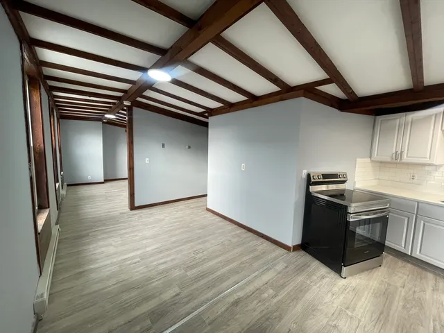 a kitchen with granite countertop a stove and a refrigerator