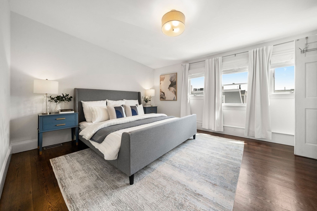 3 Glover Court, Unit 2 Boston, MA 02127 - Photo 12 of 27 a bedroom with a bed and wooden floor