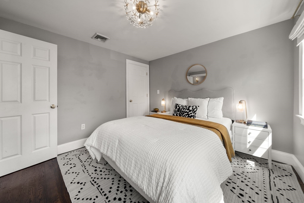 3 Glover Court, Unit 2 Boston, MA 02127 - Photo 18 of 27 a bedroom with bed and wooden floor