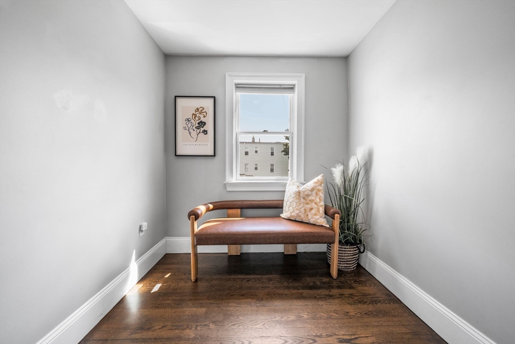 3 Glover Court, Unit 2 Boston, MA 02127 - Photo 19 of 27 a room with a wooden floor and a chair