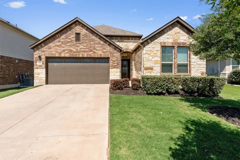 a front view of a house with yard