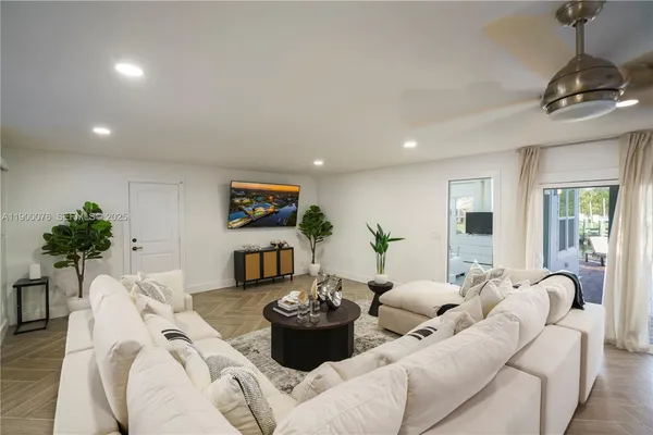 a bedroom with a bed and a large mirror