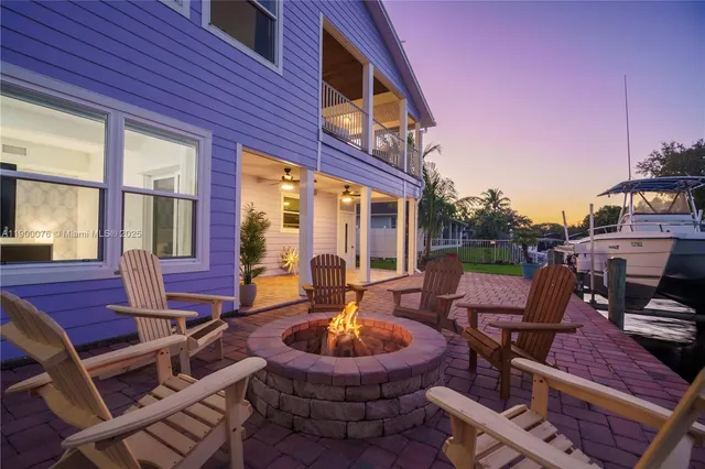 a aerial view of a house with swimming pool next to a yard