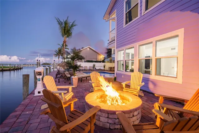 an aerial view of a house with a swimming pool patio and outdoor seating