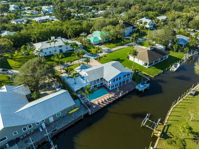 an aerial view of a house with a lake view