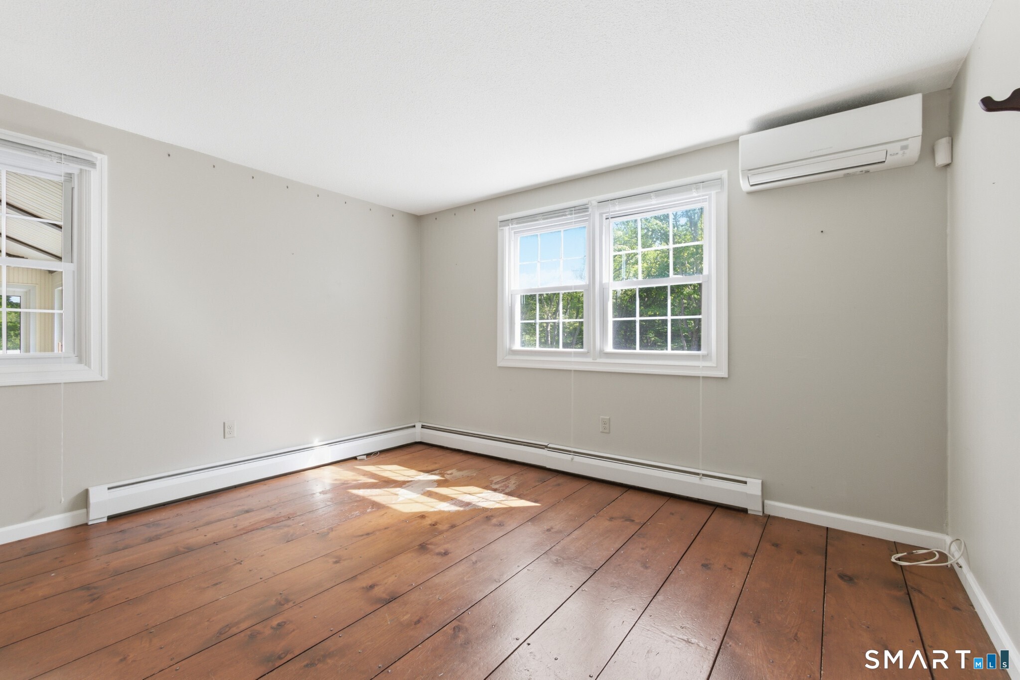 70 Mahoney Road Colchester, CT 06415 - Photo 19 of 40 a view of an empty room with wooden floor and a window