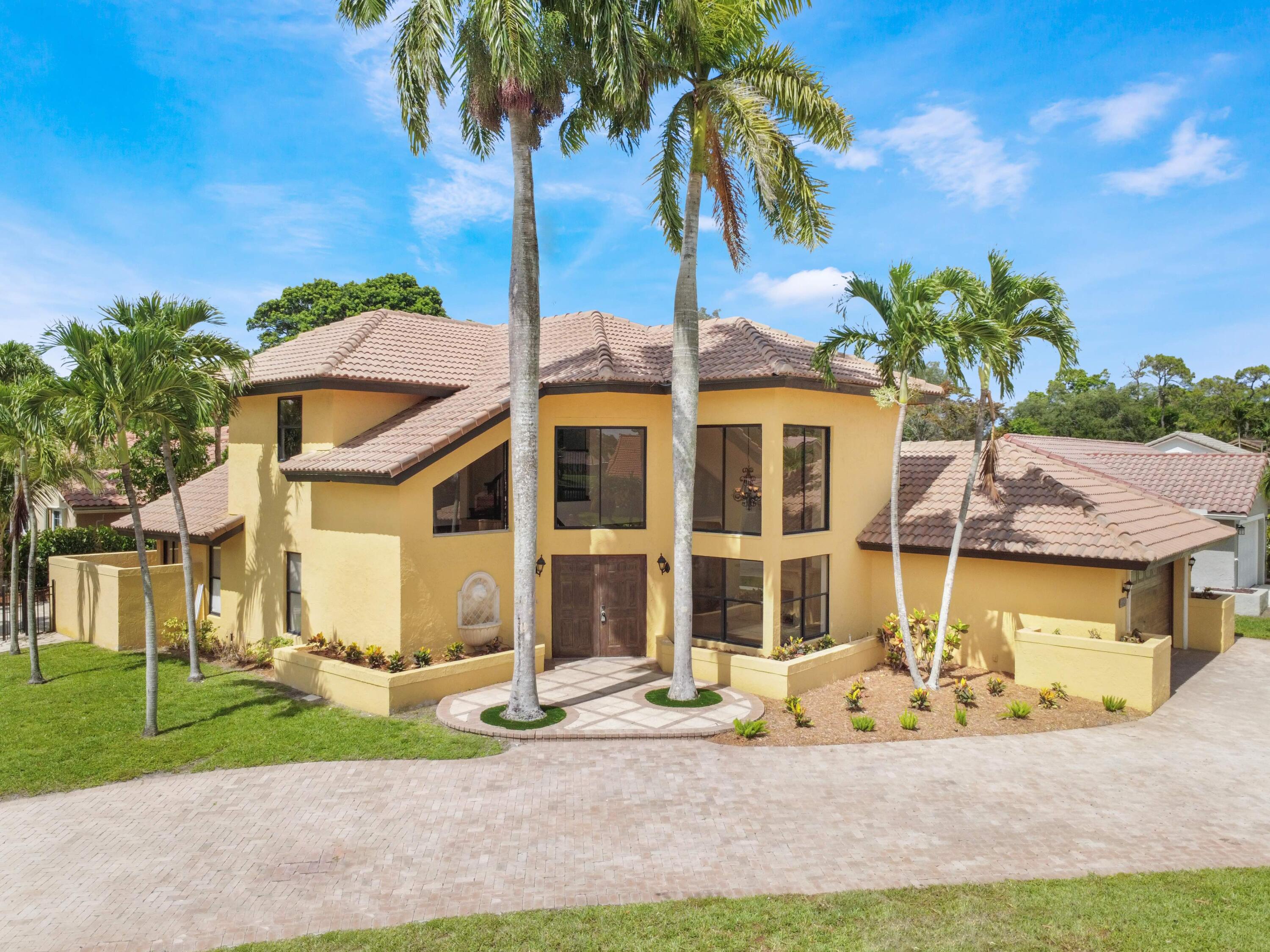 21130 White Oak Avenue Boca Raton, FL 33428 - Photo 1 of 38 a front view of a house with a garden and yard