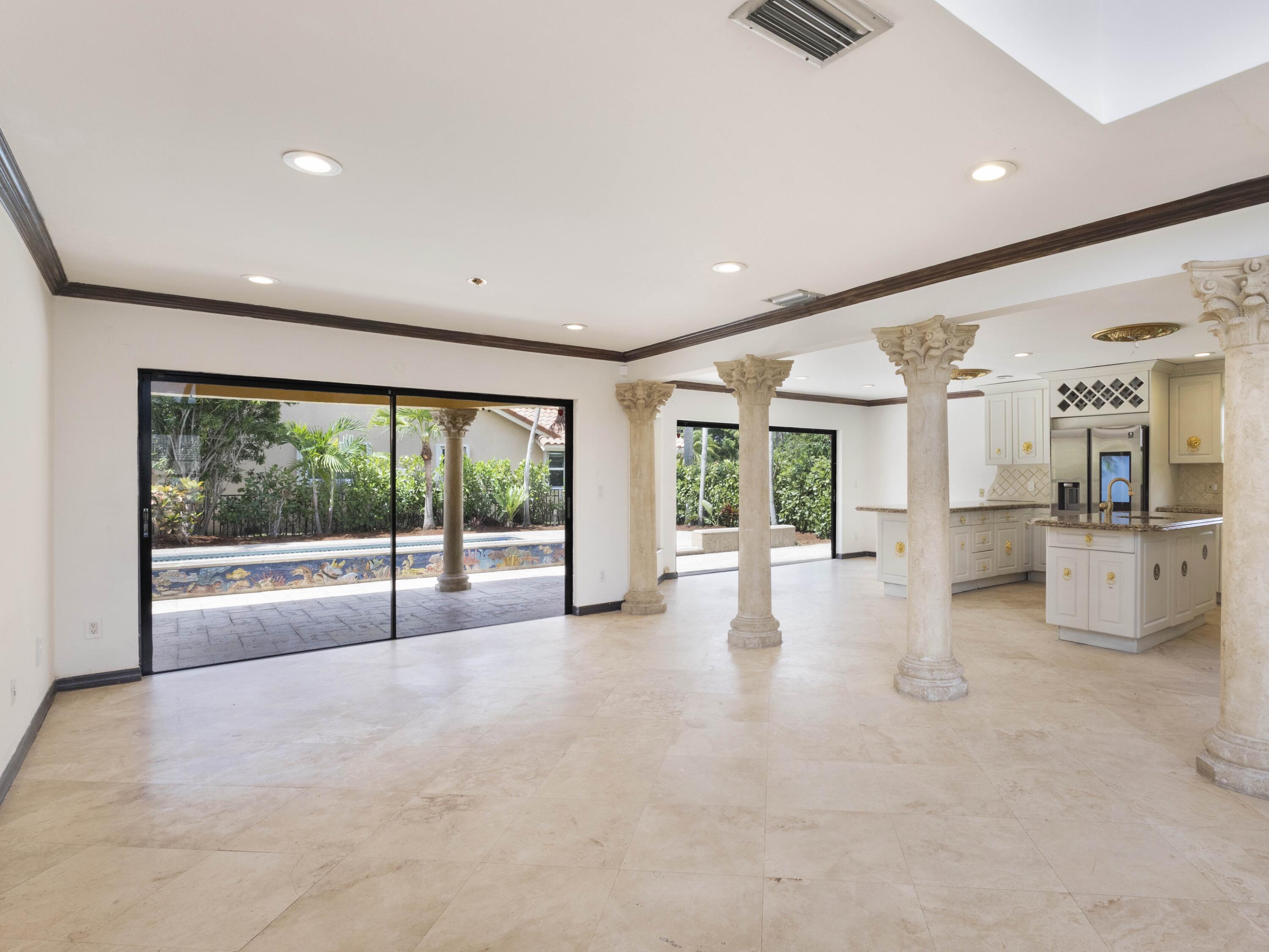 21130 White Oak Avenue Boca Raton, FL 33428 - Photo 11 of 38 a view of an empty room with a fireplace and large windows