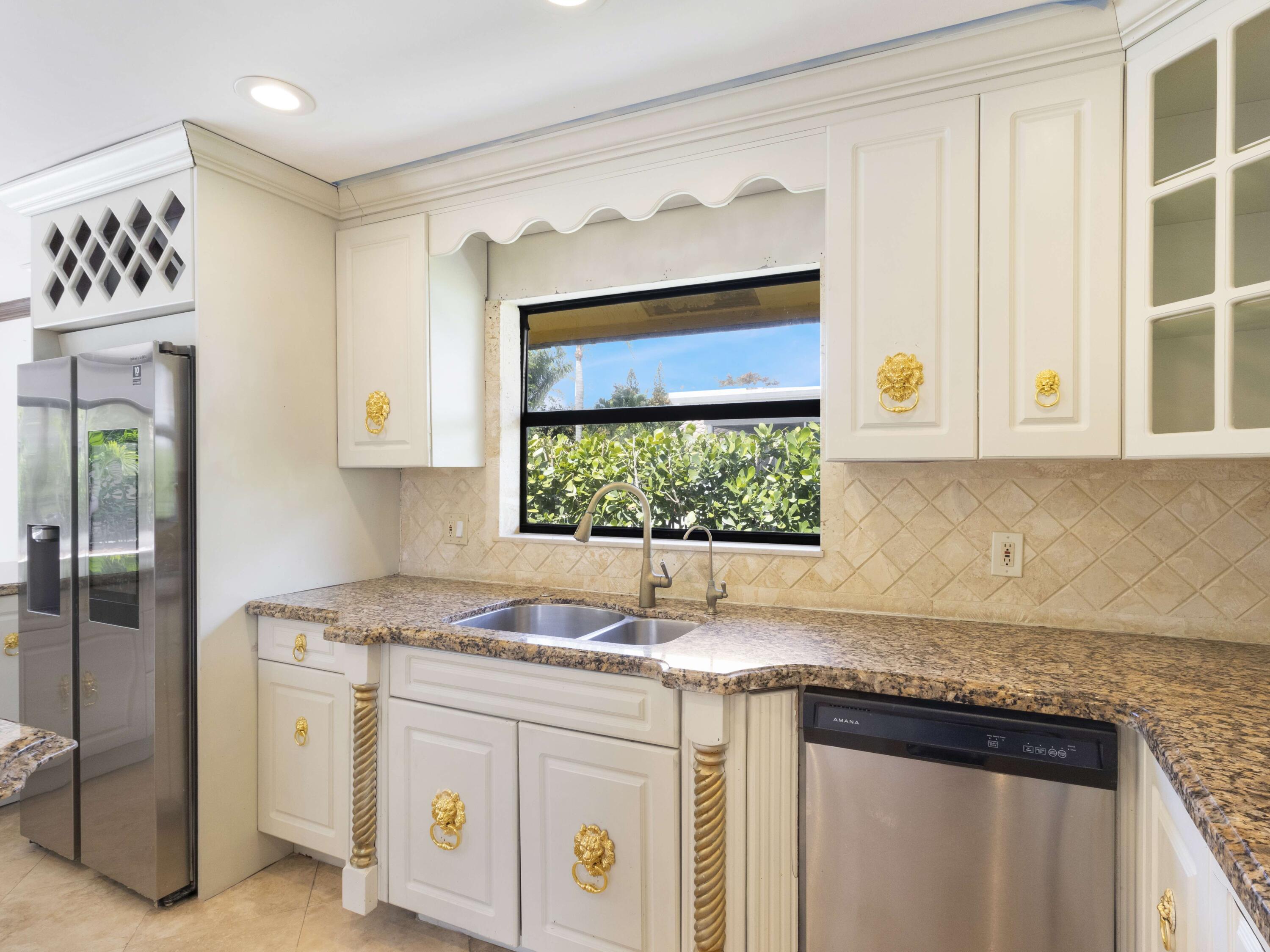 21130 White Oak Avenue Boca Raton, FL 33428 - Photo 15 of 38 a kitchen with granite countertop white cabinets and window