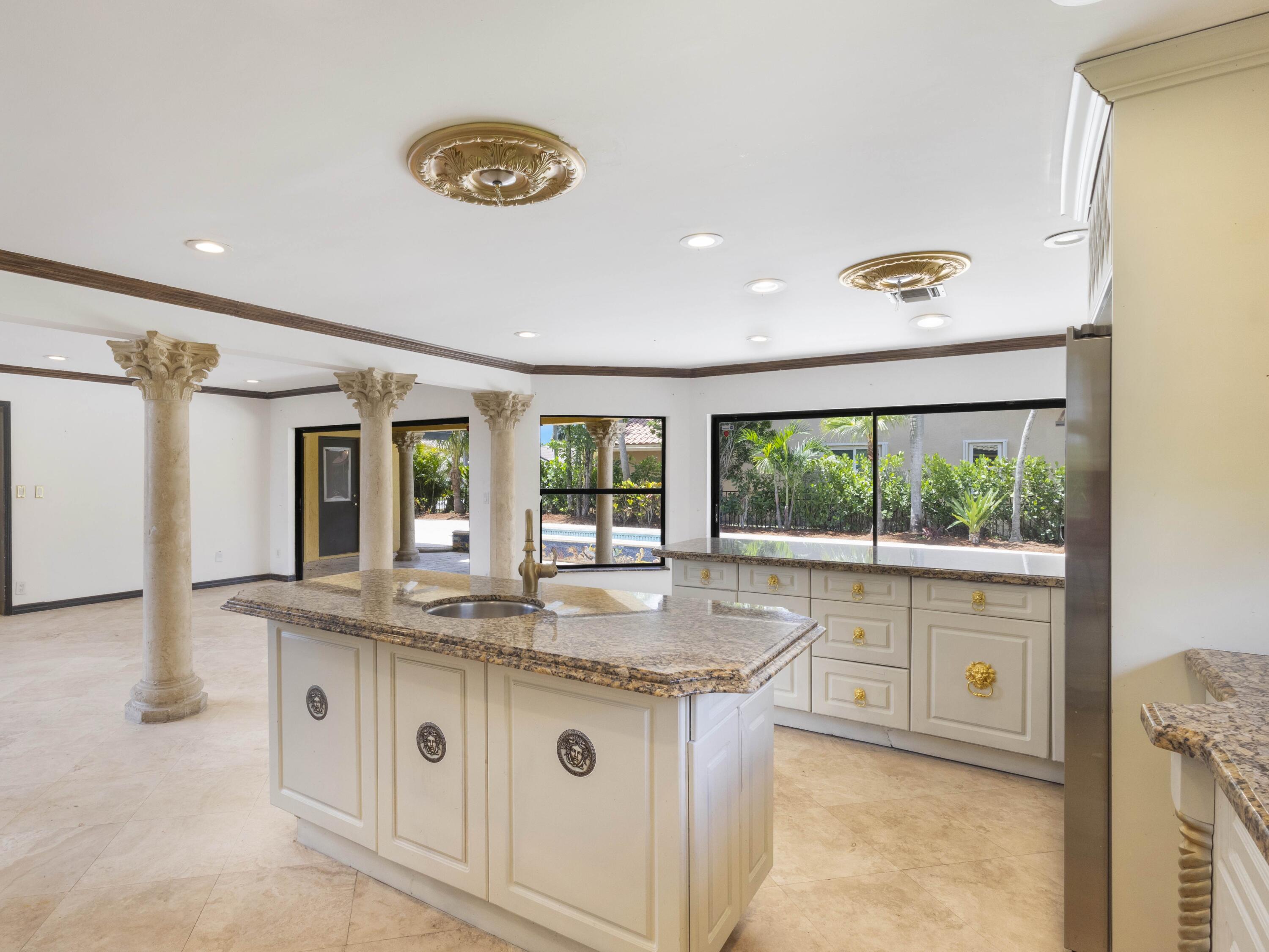 21130 White Oak Avenue Boca Raton, FL 33428 - Photo 16 of 38 a kitchen with granite countertop a stove a sink and a wooden floors