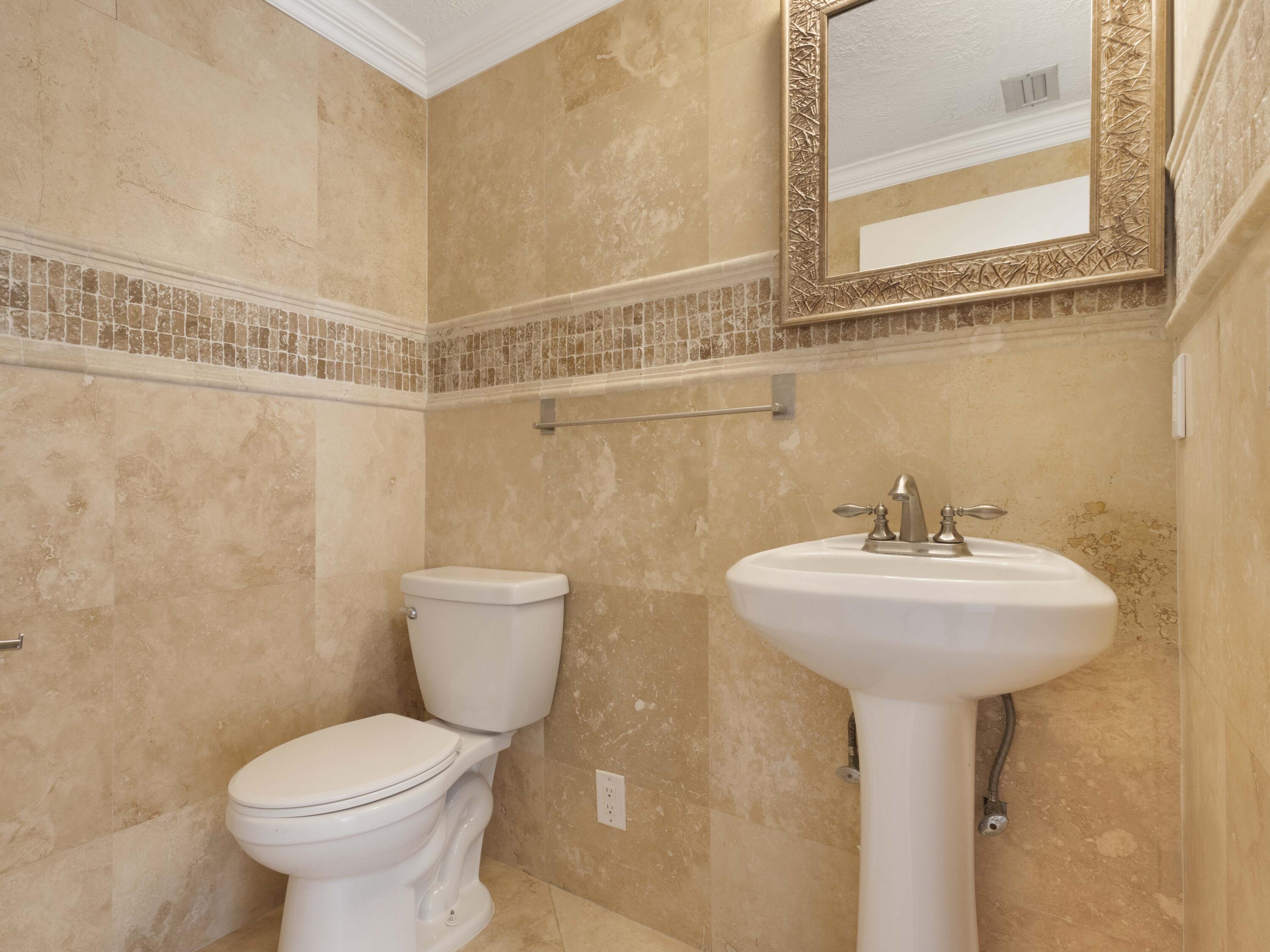 21130 White Oak Avenue Boca Raton, FL 33428 - Photo 17 of 38 a bathroom with a sink toilet and a mirror