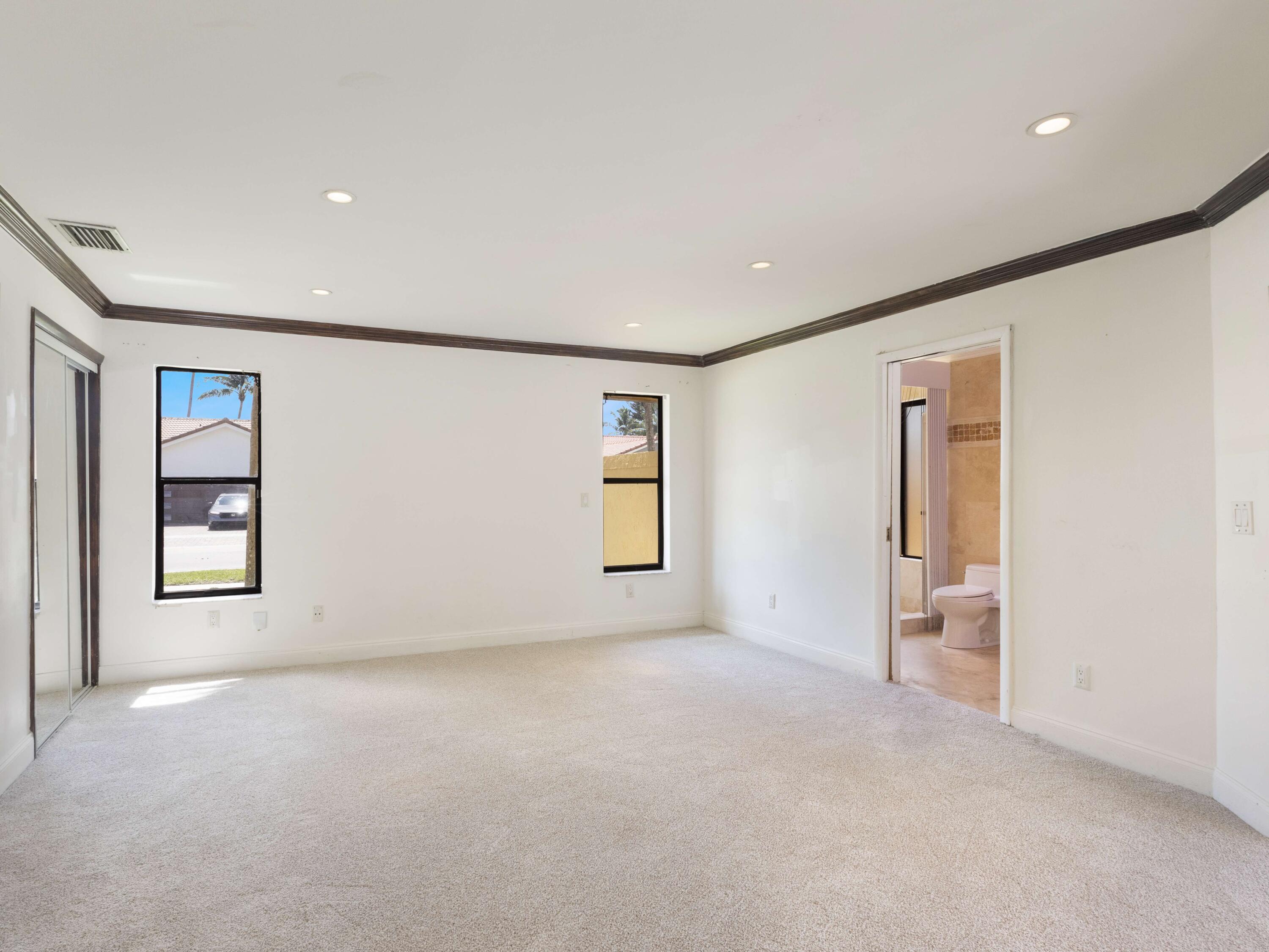 21130 White Oak Avenue Boca Raton, FL 33428 - Photo 18 of 38 an empty room with windows and cabinet