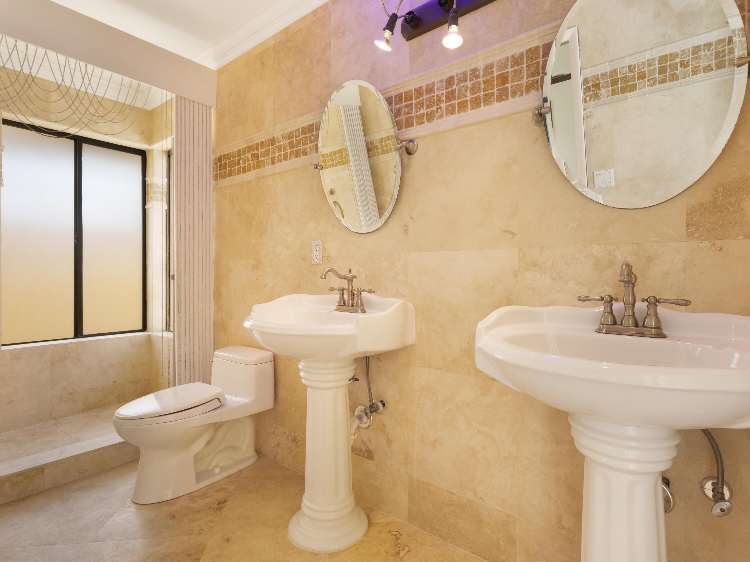 21130 White Oak Avenue Boca Raton, FL 33428 - Photo 20 of 38 a bathroom with a sink toilet and a mirror