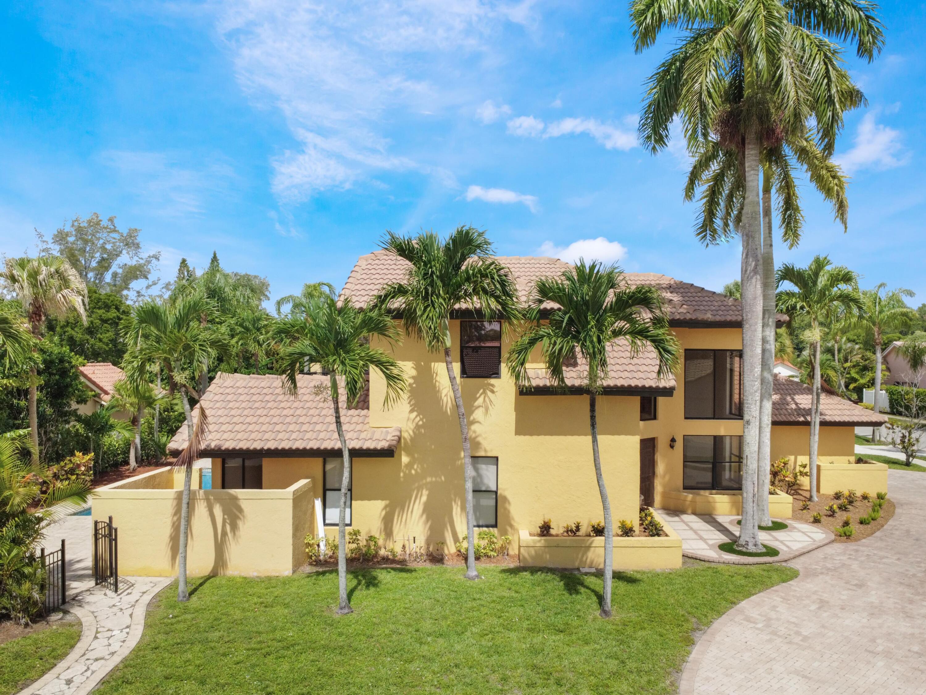 21130 White Oak Avenue Boca Raton, FL 33428 - Photo 2 of 38 a front view of a house with garden