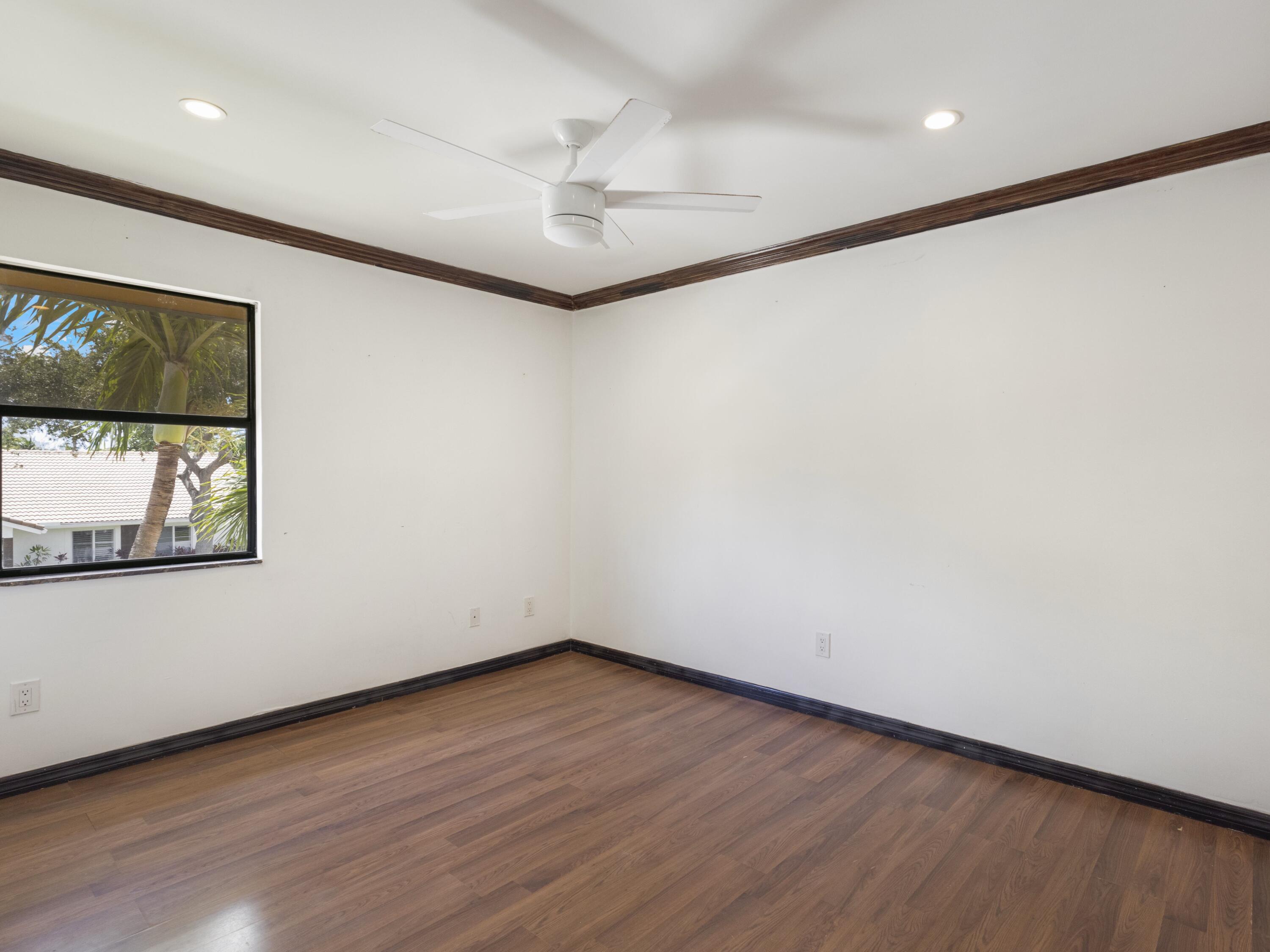 21130 White Oak Avenue Boca Raton, FL 33428 - Photo 26 of 38 an empty room with wooden floor and windows