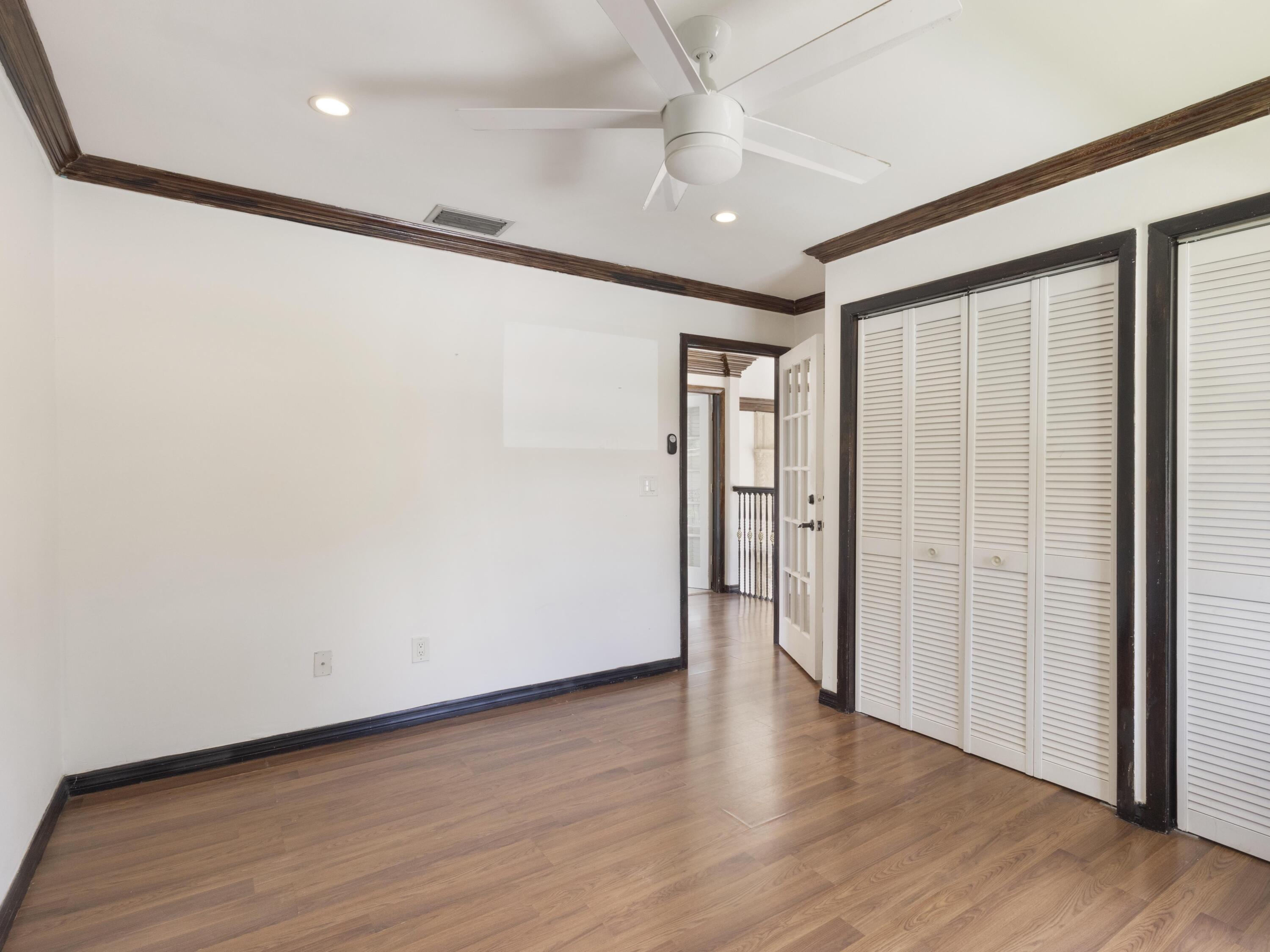 21130 White Oak Avenue Boca Raton, FL 33428 - Photo 27 of 38 an empty room with wooden floor and a ceiling fan