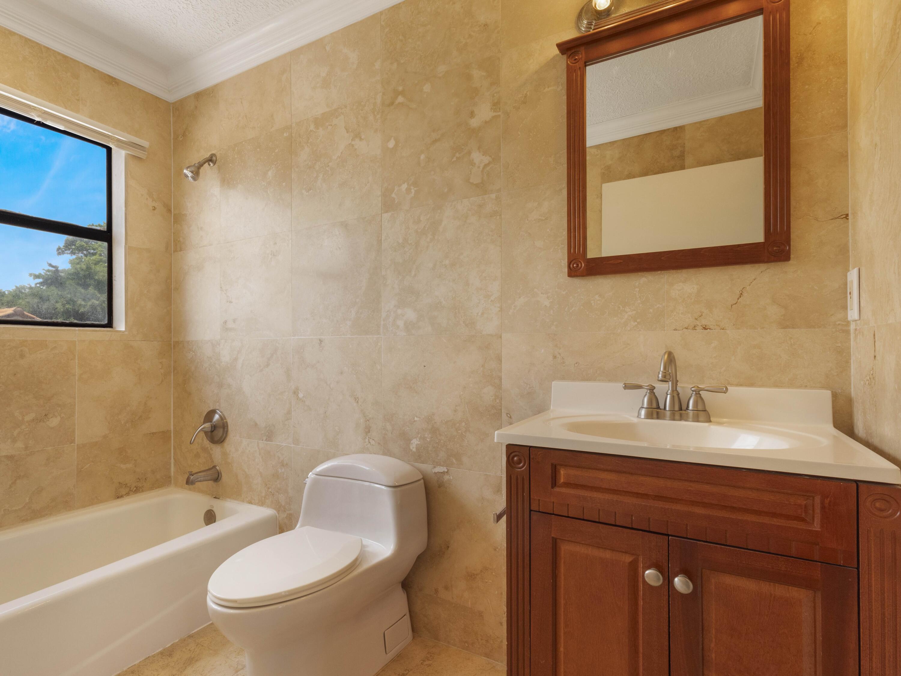 21130 White Oak Avenue Boca Raton, FL 33428 - Photo 28 of 38 a bathroom with a sink a toilet and shower