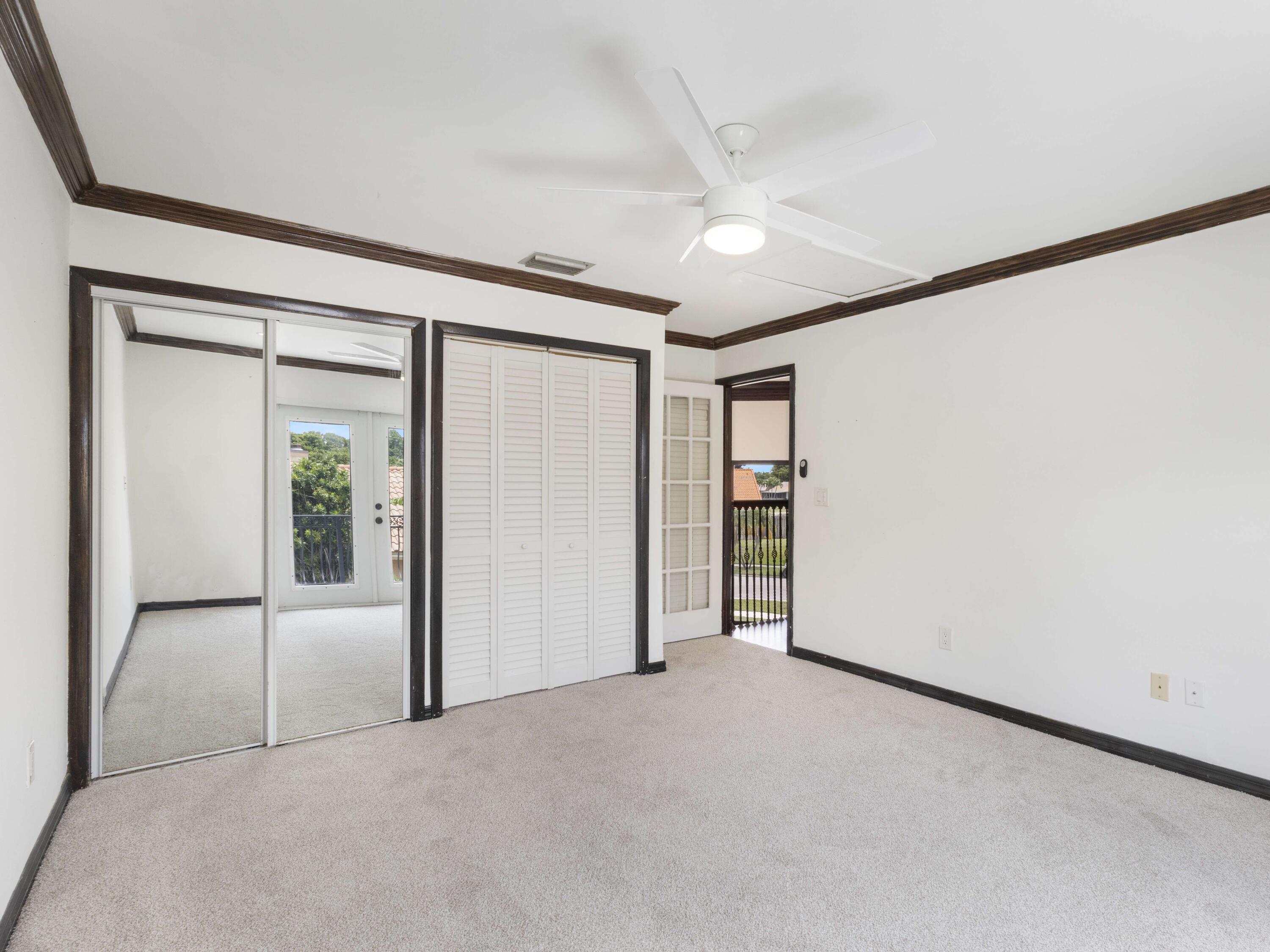 21130 White Oak Avenue Boca Raton, FL 33428 - Photo 30 of 38 an empty room with closet and a ceiling fan
