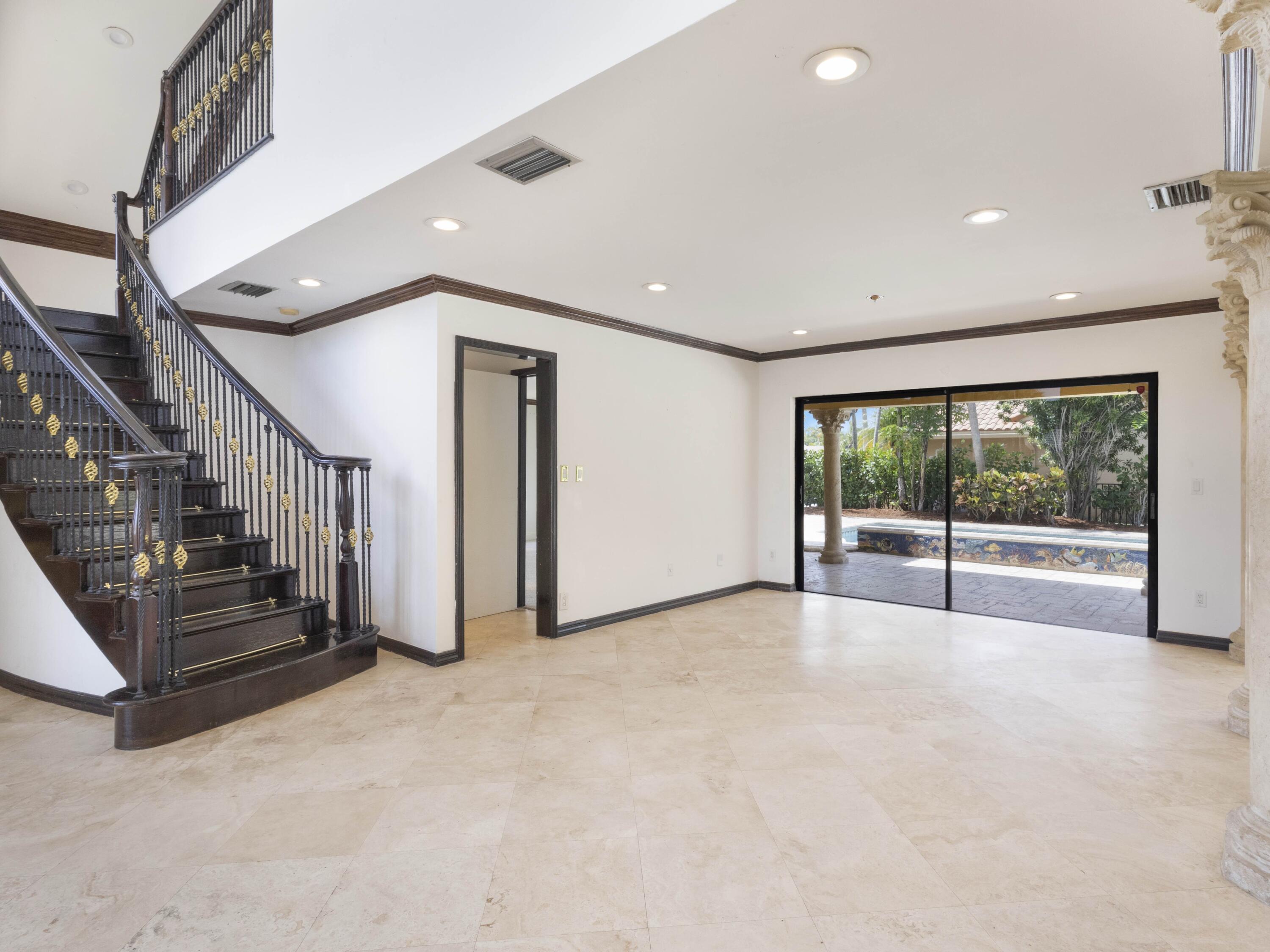 21130 White Oak Avenue Boca Raton, FL 33428 - Photo 9 of 38 a view of an empty room with wooden floor and stairs