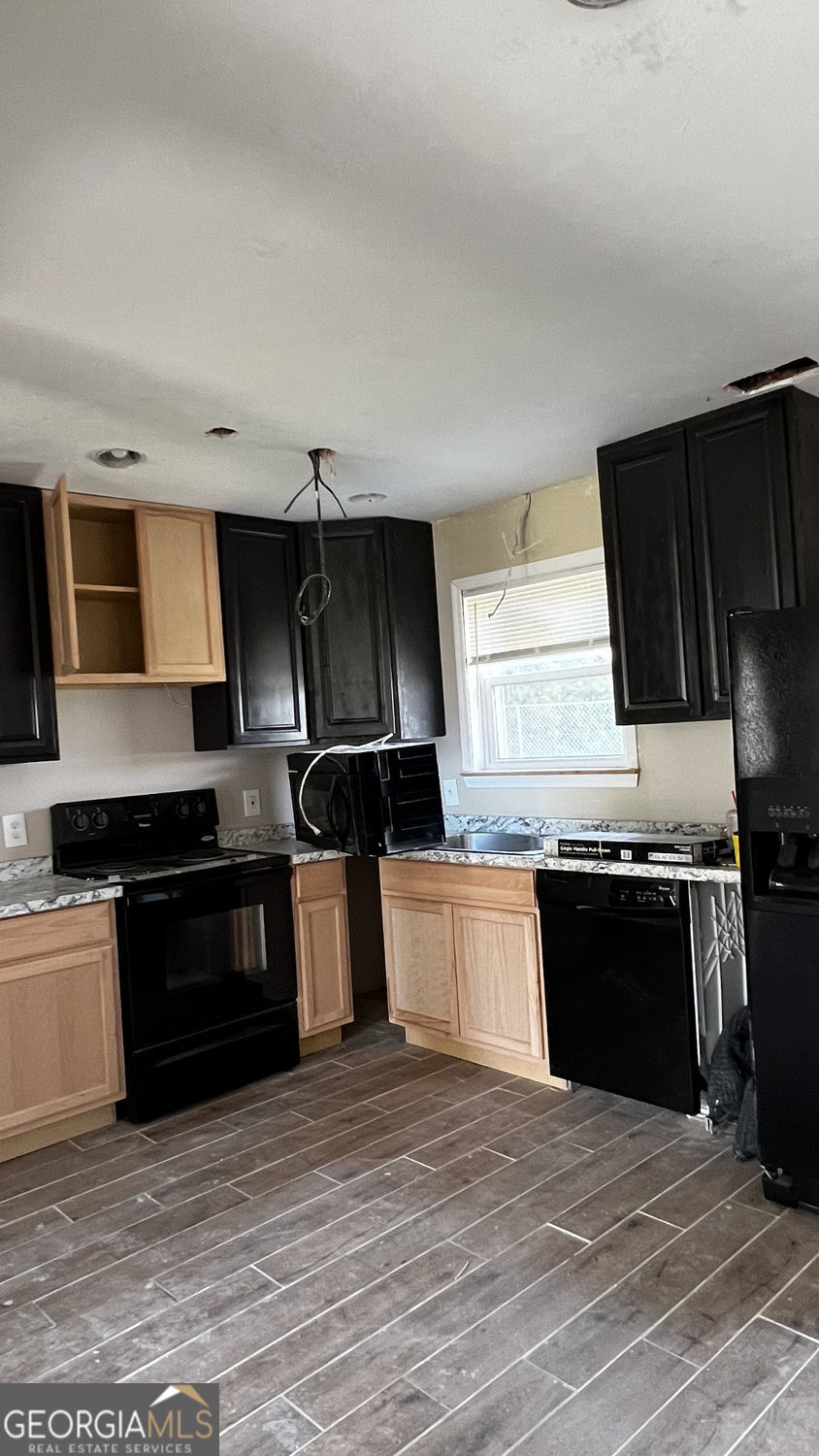156 East Geer Street Colquitt, GA 39837 - Photo 16 of 19 a kitchen with granite countertop stainless steel appliances and wooden cabinets
