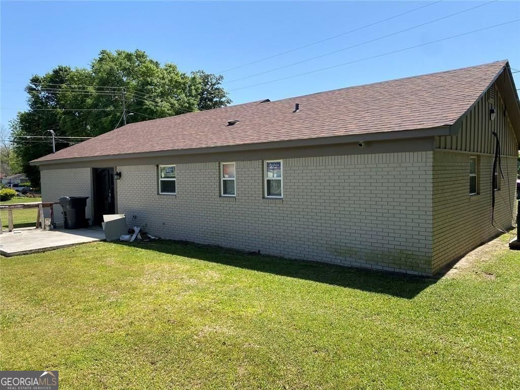156 East Geer Street Colquitt, GA 39837 - Photo 2 of 19 a view of a house with pool and chairs