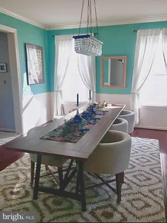 a kitchen with stainless steel appliances granite countertop a refrigerator a stove and a wooden floors