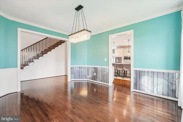 a large kitchen with stainless steel appliances kitchen island granite countertop a sink and cabinets