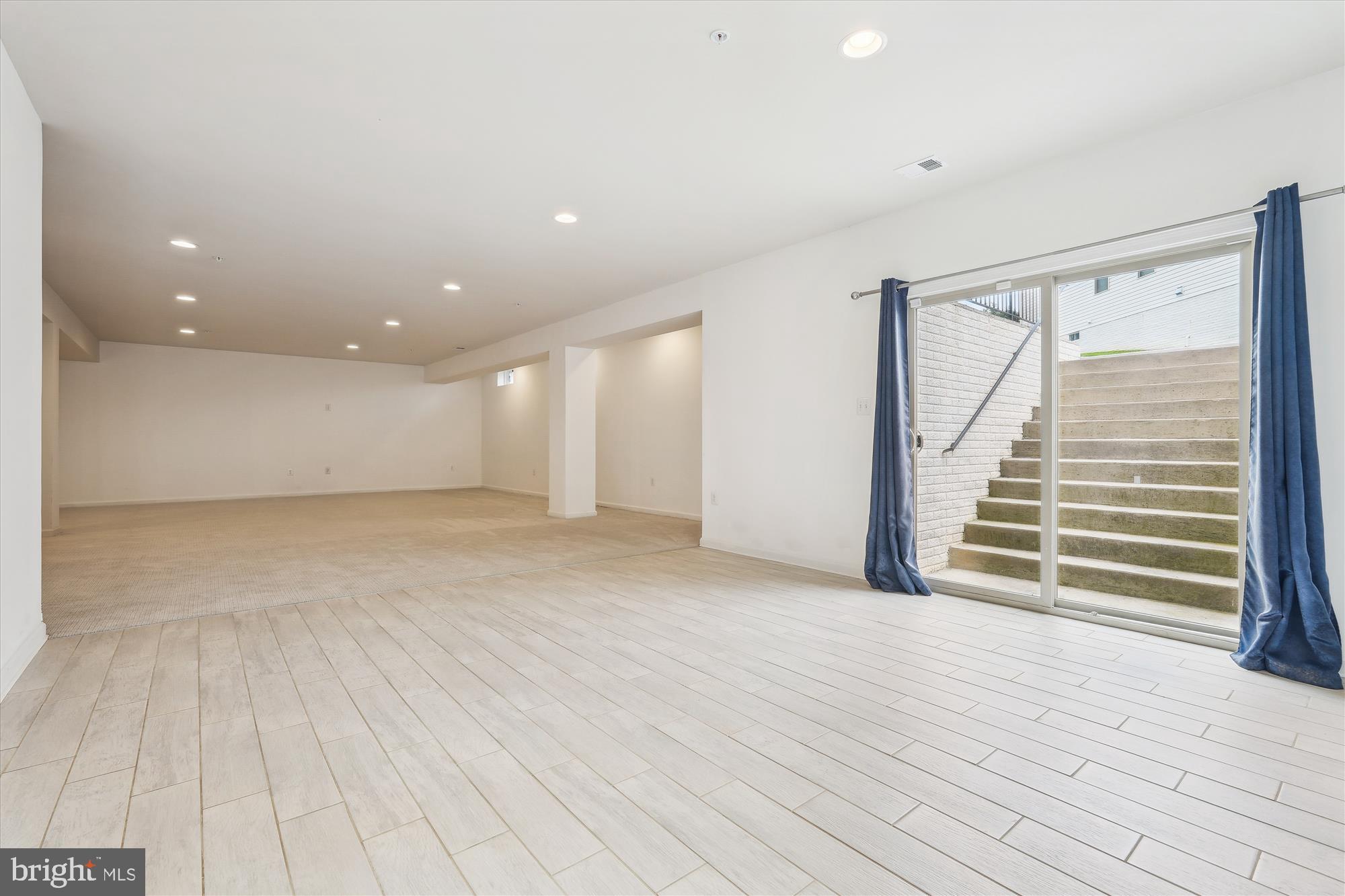 1105 Sweetbay Place Silver Spring, MD 20906 - Photo 60 of 111 a view of an empty room with wooden floor and stairs