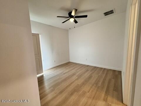 5719 Kemper Street, Unit A Lubbock, TX 79416 - Photo 13 of 21 an empty room with wooden floor and ceiling fan