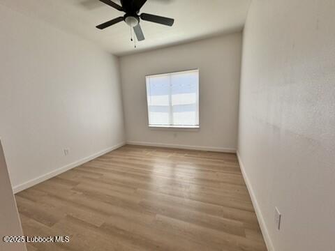 5719 Kemper Street, Unit A Lubbock, TX 79416 - Photo 16 of 21 an empty room with wooden floor fan and windows