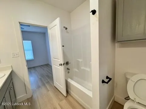 a view of a room with wooden floor and a sink