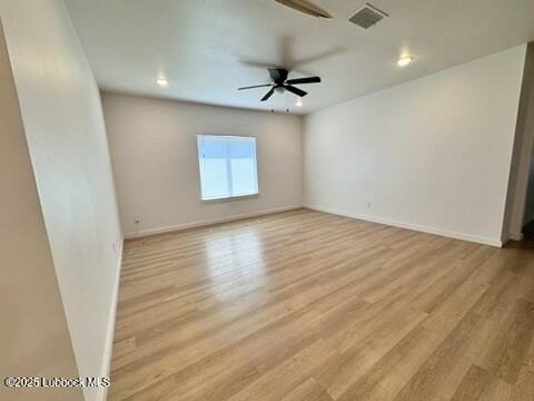 5719 Kemper Street, Unit A Lubbock, TX 79416 - Photo 4 of 21 wooden floor in an empty room with a window