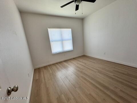 5719 Kemper Street, Unit A Lubbock, TX 79416 - Photo 9 of 21 wooden floor in an empty room with a window