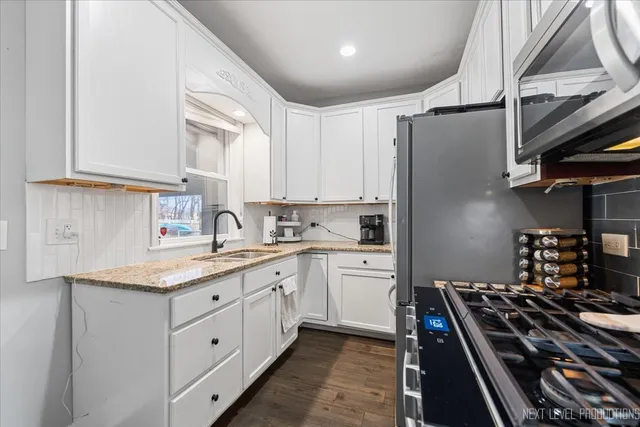 a bedroom with a bed and a flat tv screen on the dresser