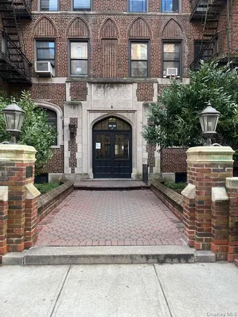 a front view of a building with plants