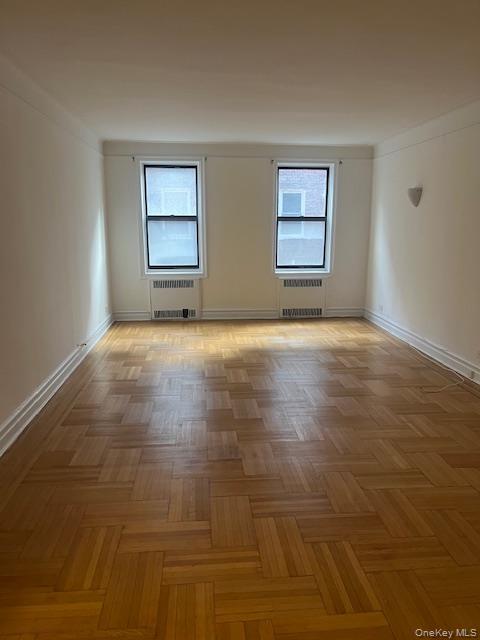 110-20 73rd Road, Unit 3E Queens, NY 11375 - Photo 4 of 10 a view of an empty room with window