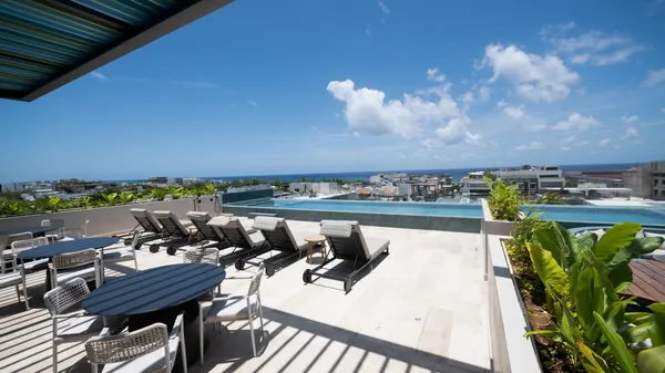 a view of a swimming pool and lounge chairs