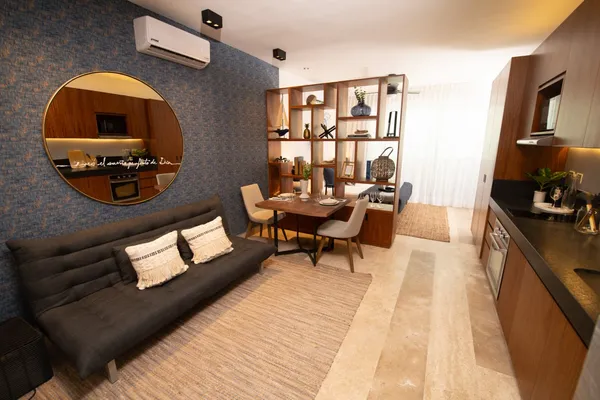 a living room with furniture and a wooden floor