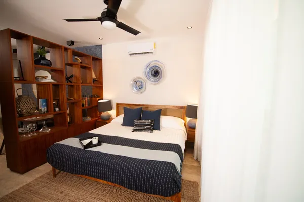 a bedroom with a bed and a window