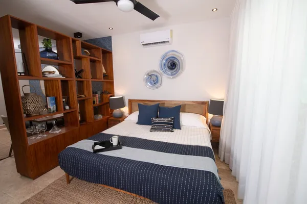 a bedroom with a bed and cabinets