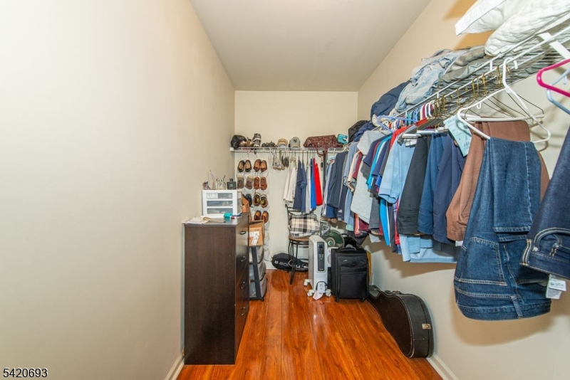 375 Rifle Camp Road, Unit 403 Woodland Park, NJ 07424 - Photo 11 of 24 a view of walk in closet with clothes