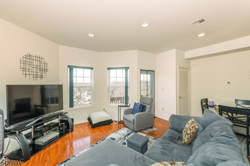 375 Rifle Camp Road, Unit 403 Woodland Park, NJ 07424 - Photo 12 of 24 a living room with furniture tv and a flat screen tv