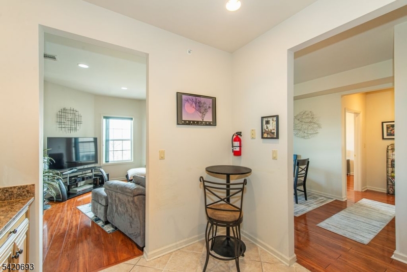 375 Rifle Camp Road, Unit 403 Woodland Park, NJ 07424 - Photo 13 of 24 a living room with furniture and a flat screen tv
