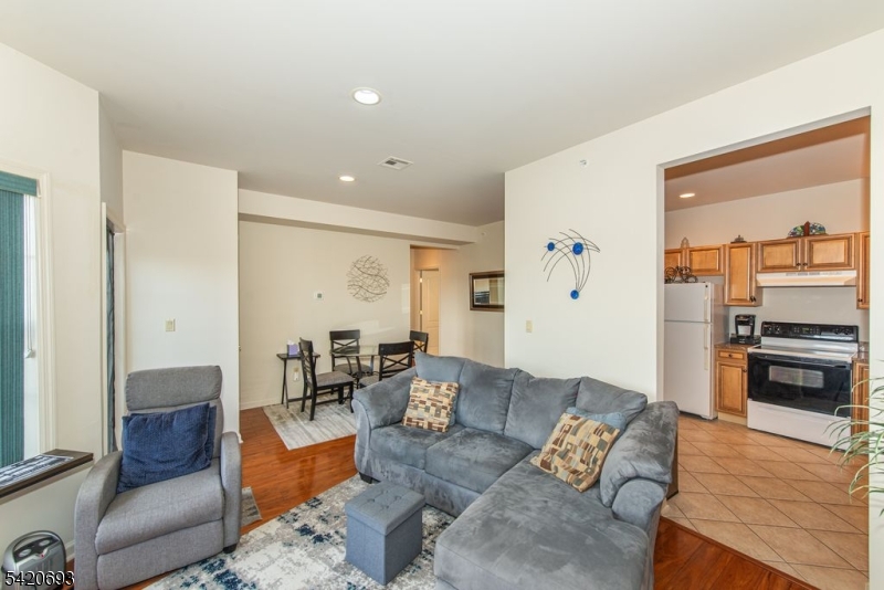 375 Rifle Camp Road, Unit 403 Woodland Park, NJ 07424 - Photo 16 of 24 a living room with furniture and kitchen view
