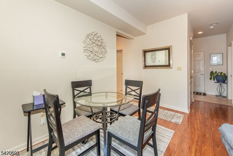 375 Rifle Camp Road, Unit 403 Woodland Park, NJ 07424 - Photo 18 of 24 a view of a livingroom with furniture and wooden floor