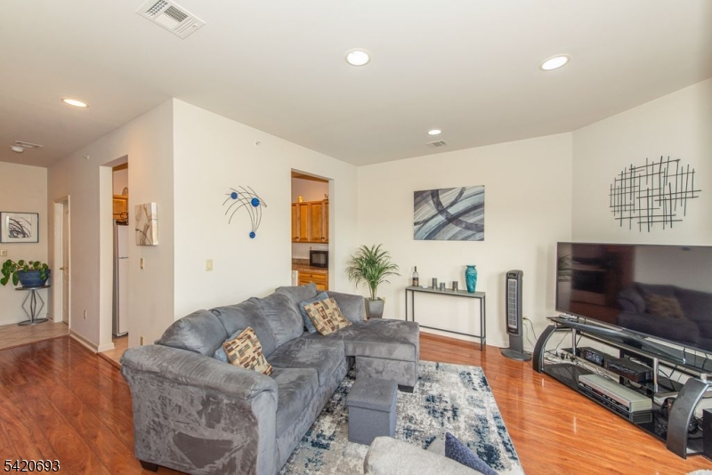 375 Rifle Camp Road, Unit 403 Woodland Park, NJ 07424 - Photo 23 of 24 a living room with furniture and a flat screen tv