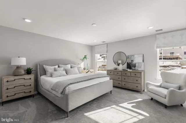 a bedroom with bed and white cabinets