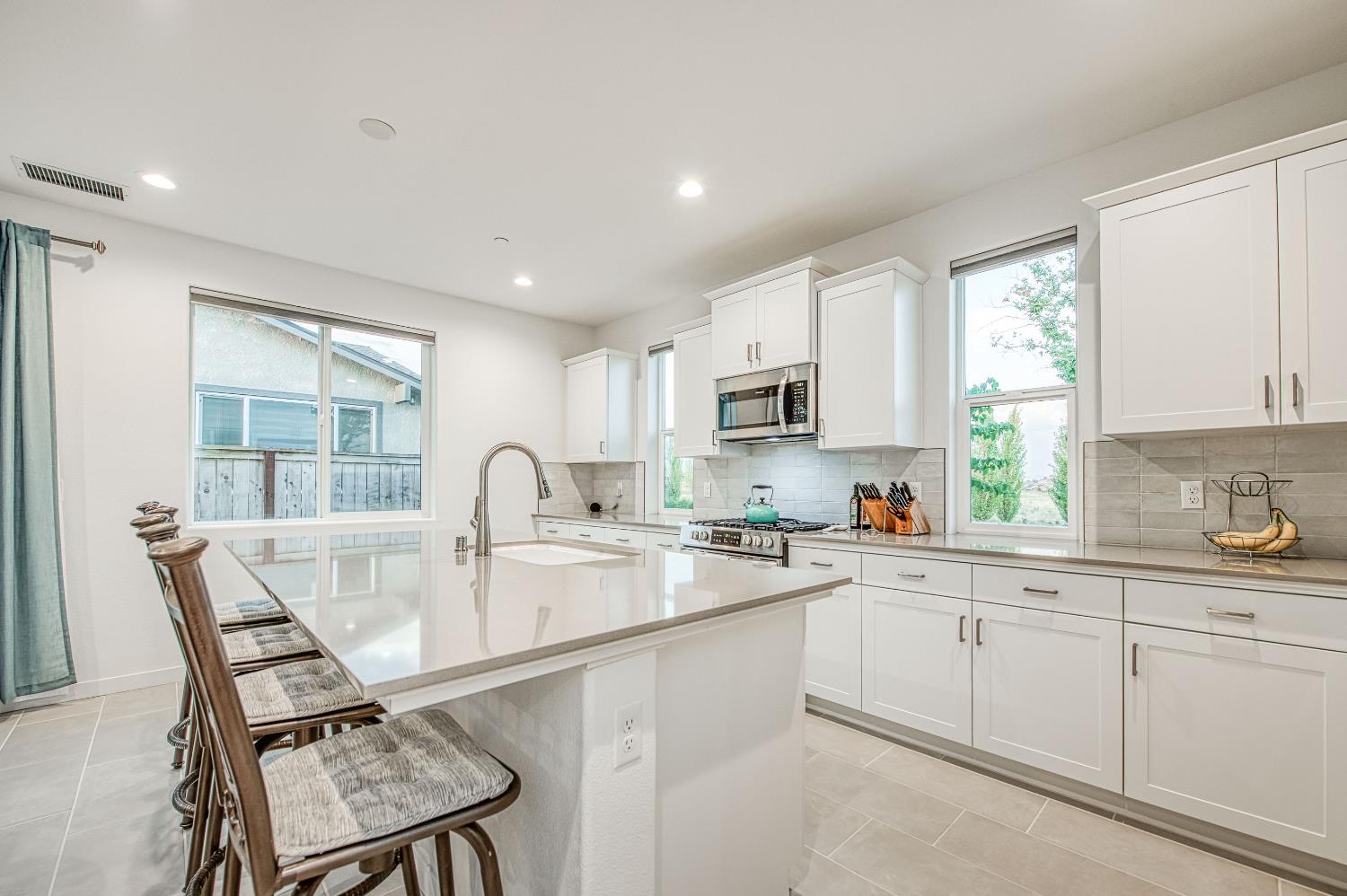 849 Livio Way Madera, CA 93636 - Photo 24 of 74 a kitchen with white cabinets a sink and appliances